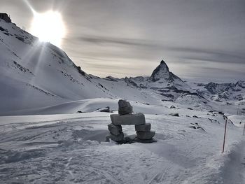 Rear view of person on snow covered mountain against sky