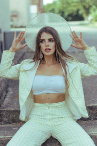 Portrait of young woman wearing hat
