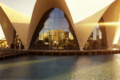 Bridge over river against buildings in city