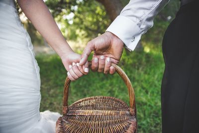 Midsection of couple holding hands