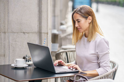 Businesswoman using laptop at office