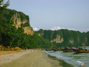 Scenic view of sea and mountains against sky