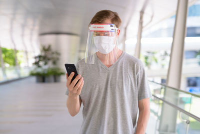 Man wearing face mask standing outdoors