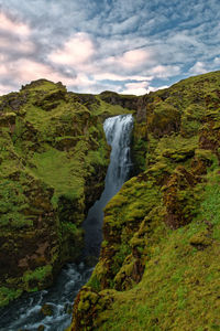Scenic view of waterfall against sky