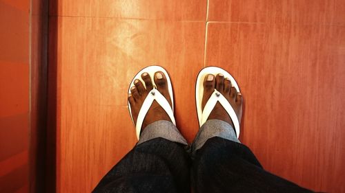 Low section of woman walking on tiled floor