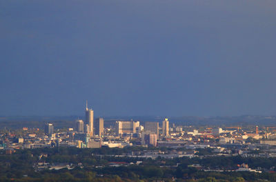 Buildings in city against clear sky