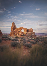 Rock formations on landscape against sky