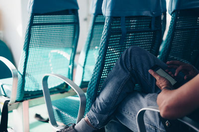 Midsection of man sitting in bus