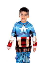 Portrait of boy standing against white background