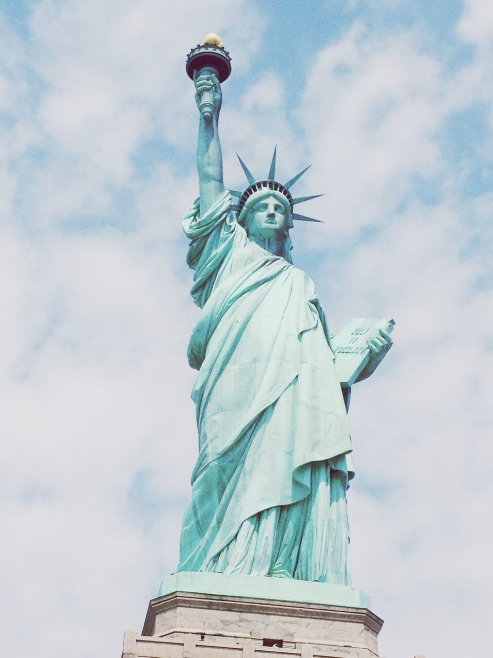 human representation, statue, sculpture, low angle view, art and craft, art, creativity, sky, cloud - sky, built structure, architecture, religion, building exterior, cloud, famous place, cloudy, spirituality