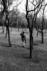 Rear view of man walking on field