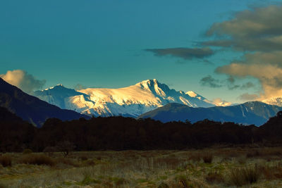 Scenic view of mountains against blue sky