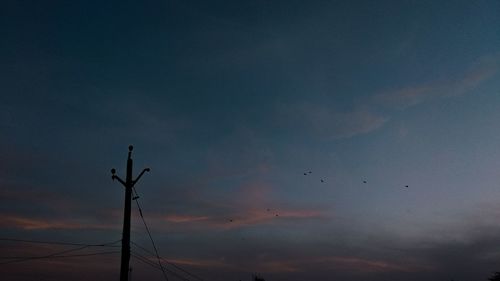 Low angle view of silhouette birds flying against sky during sunset