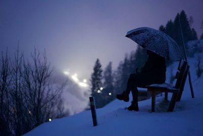 Scenic view of snow covered trees against sky at night