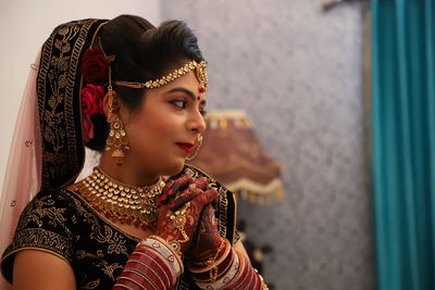 Close-up of thoughtful bride wearing sari during wedding ceremony