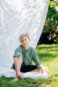 Portrait of young man sitting on tent