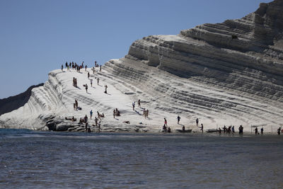 Group of people on the rocks of scala dei turchi