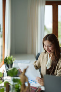 Young woman using laptop at home