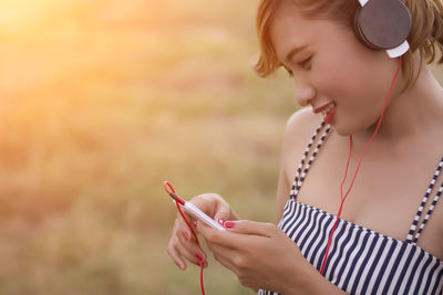 Close-up of woman listening music