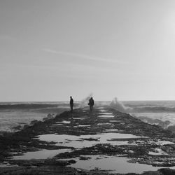 People on beach against sky