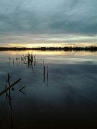 Scenic view of lake against cloudy sky