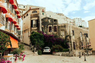 Street amidst buildings in city against sky
