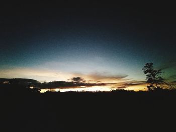 Scenic view of silhouette landscape against sky at sunset