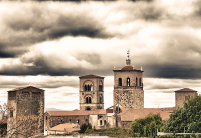 Buildings against cloudy sky