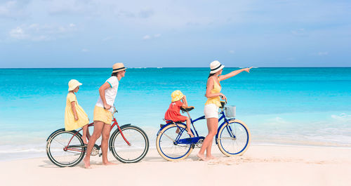 Bicycles on beach against sky