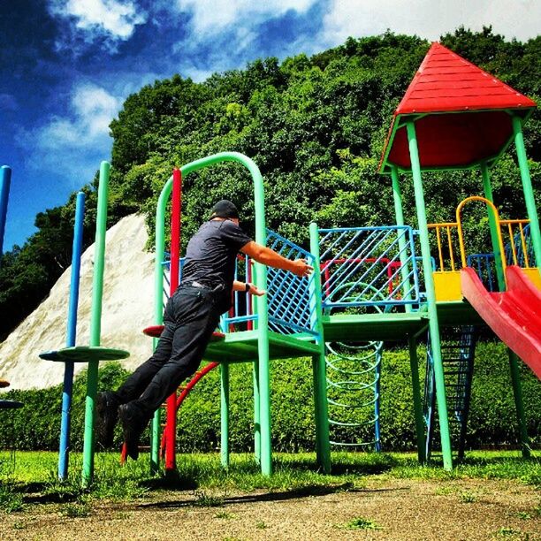 tree, absence, empty, sky, grass, chair, red, playground, bench, built structure, tranquility, day, park - man made space, flag, no people, seat, nature, outdoors, wood - material, field