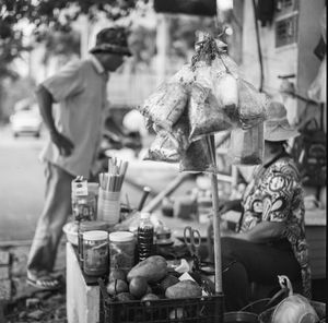 People for sale at market stall