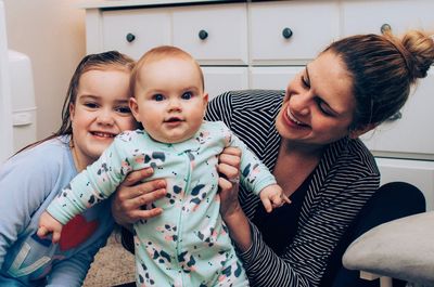 Happy mother with kids at home