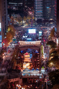 High angle view of city lit up at night