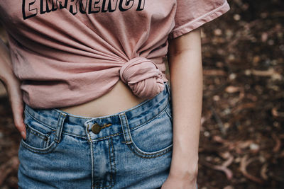 Midsection of woman standing against blurred background