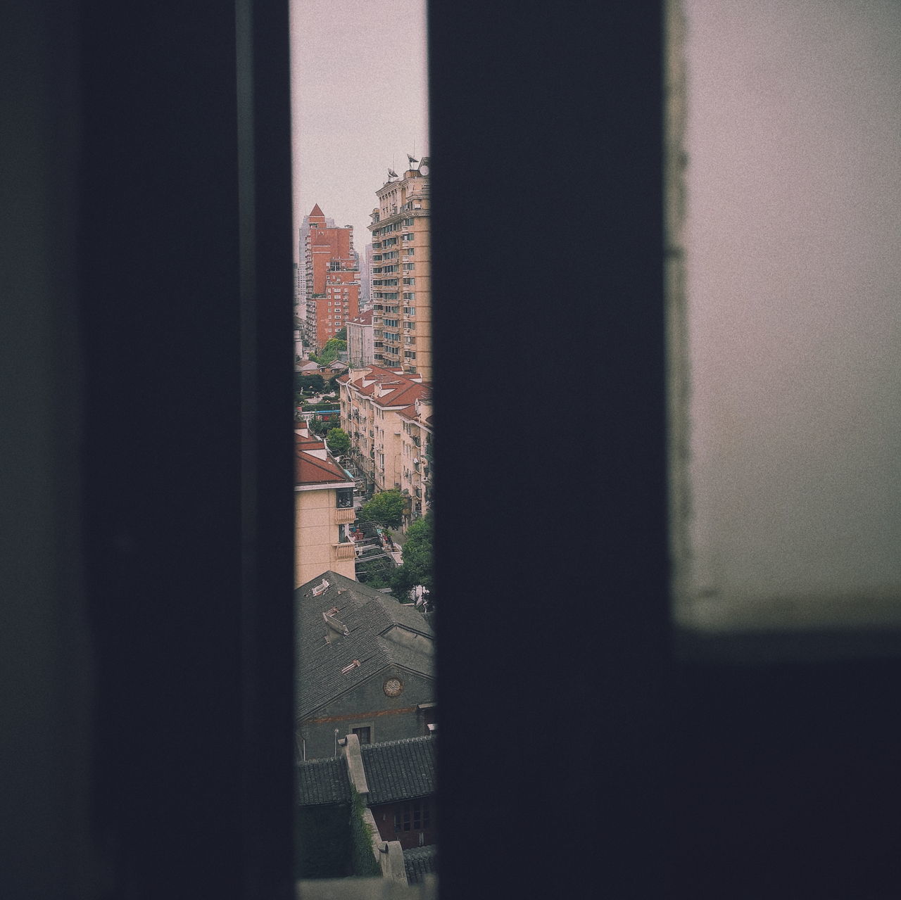 BUILDINGS AGAINST CLEAR SKY SEEN THROUGH GLASS WINDOW