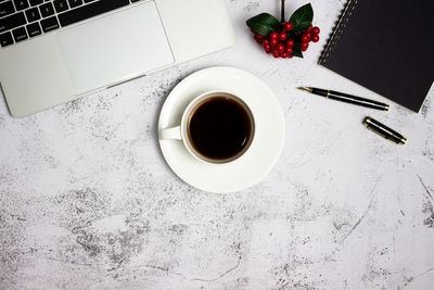 Directly above shot of coffee and book on table