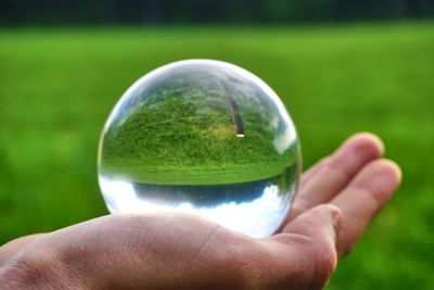 Close-up of human hand holding ball