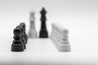 Close-up of chess pieces against white background