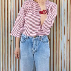 Midsection of woman standing against patterned wall