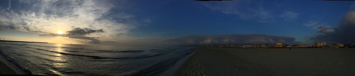 Panoramic view of beach against sky during sunset
