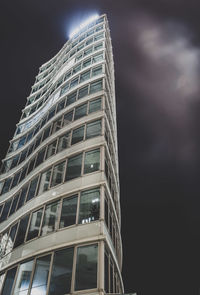 Low angle view of modern building against sky at night