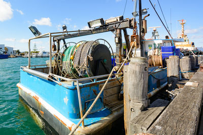 Boats moored on sea against blue sky