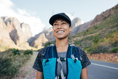 Smiling female explorer day dreaming on vacation