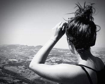 Rear view of woman looking at camera