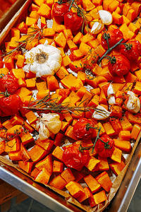 View from above on hokkaido pumpkin with garlic and herbs in pan