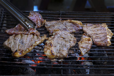 High angle view of meat on barbecue grill