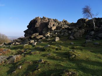 Rock formations on landscape against sky