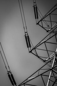 Low angle view of electricity pylon against sky