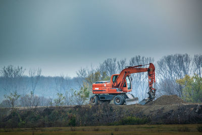 Tractor on field against sky