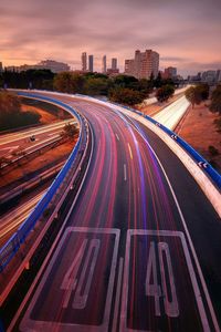 High angle view of light trails on highway at sunset